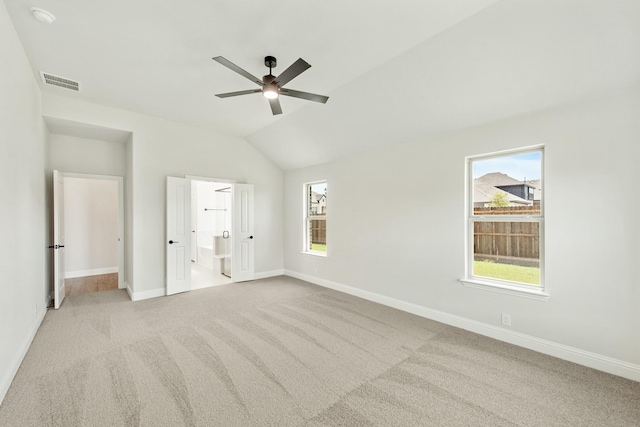 unfurnished bedroom with ensuite bath, carpet, visible vents, and baseboards