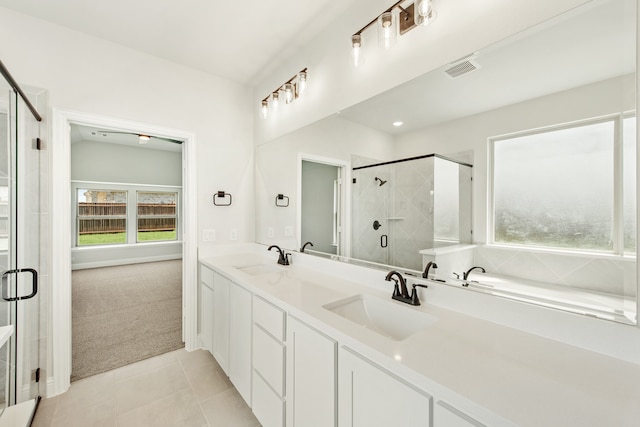 bathroom featuring a shower with shower door, tile patterned flooring, and vanity