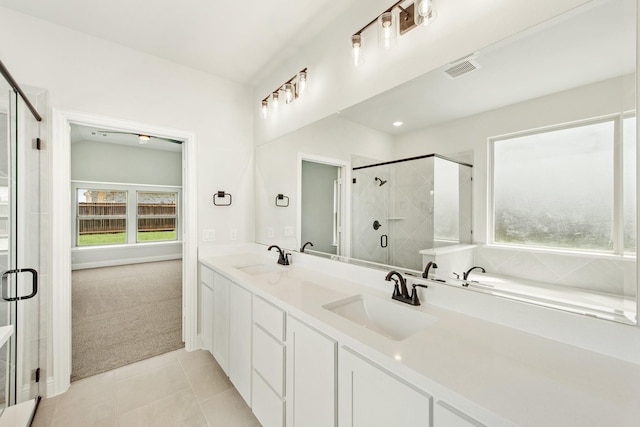 full bath with a shower stall, visible vents, a sink, and tile patterned floors