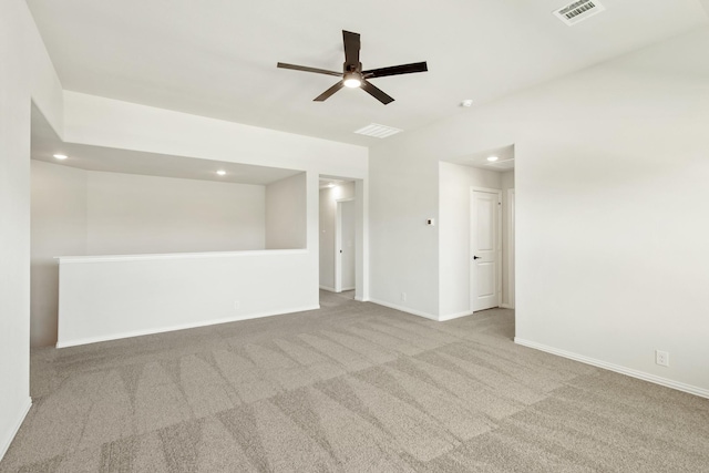 carpeted empty room featuring a ceiling fan, recessed lighting, visible vents, and baseboards