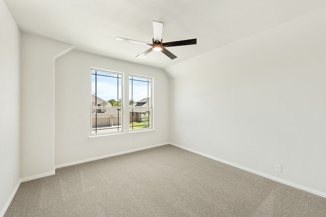 carpeted spare room with lofted ceiling and ceiling fan