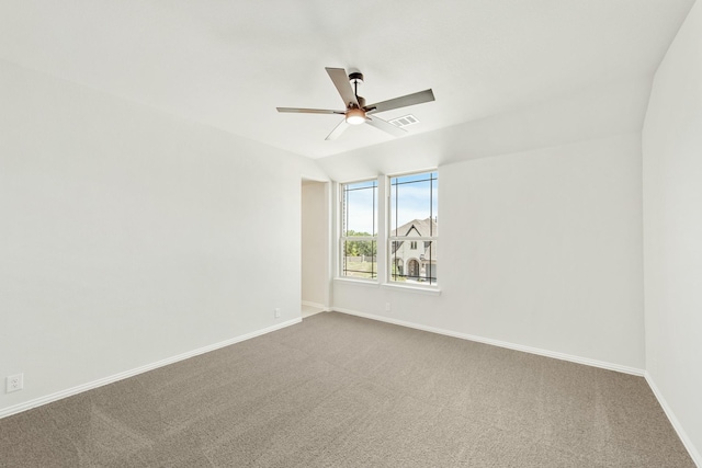 spare room with visible vents, baseboards, lofted ceiling, ceiling fan, and carpet