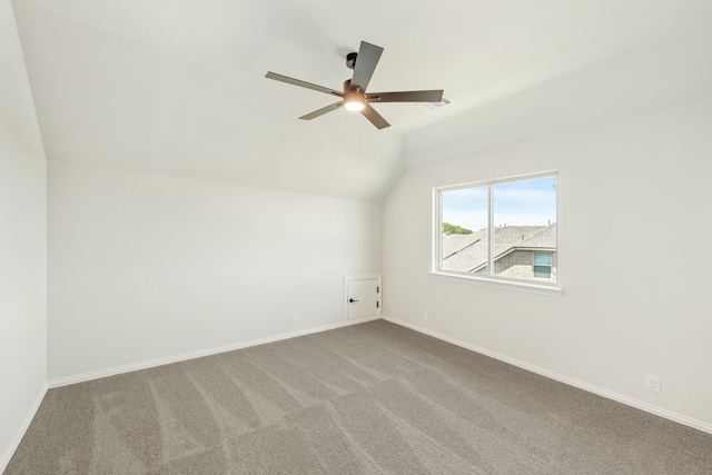 spare room with lofted ceiling, carpet, and ceiling fan