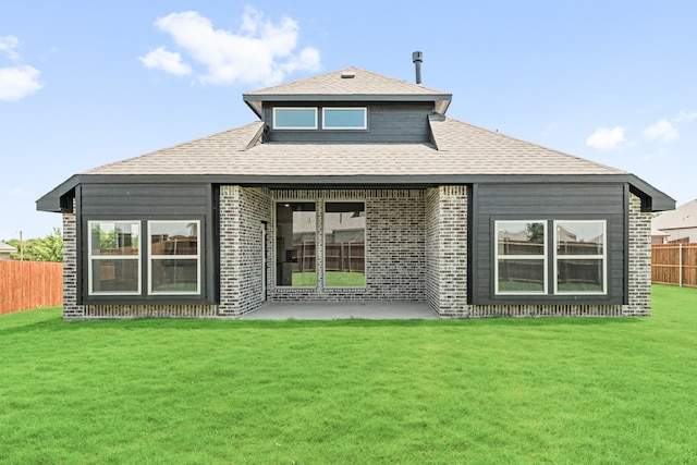 rear view of house featuring a lawn