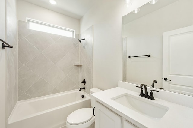 bathroom with washtub / shower combination, vanity, and toilet