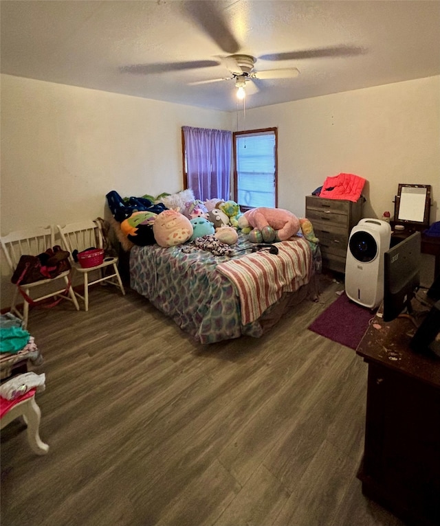 bedroom with dark wood-type flooring and ceiling fan