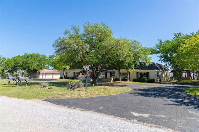 view of front of property featuring a garage and a front lawn