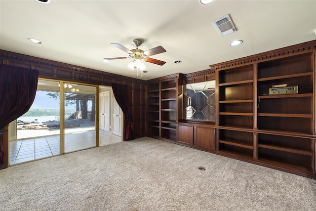 interior space with light carpet and ceiling fan