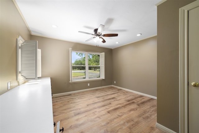 spare room with ceiling fan, light hardwood / wood-style flooring, and ornamental molding