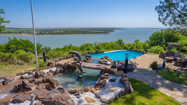 view of swimming pool featuring a water view