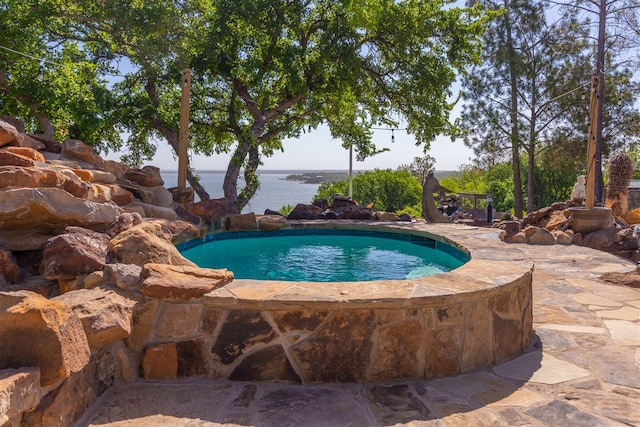 view of swimming pool featuring a water view