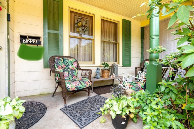 doorway to property featuring ceiling fan and a porch