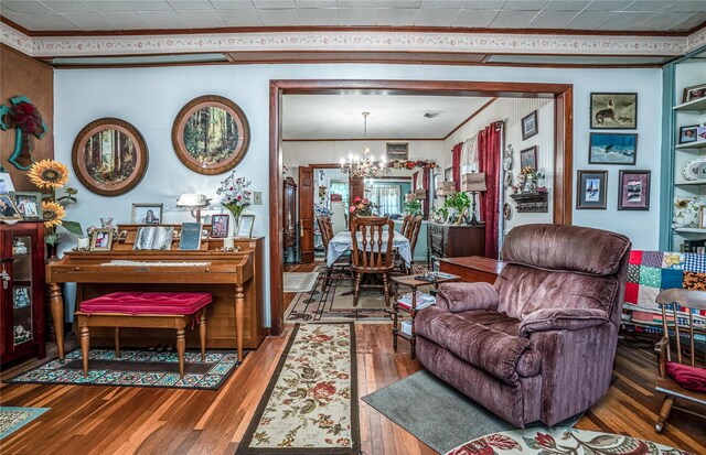 2252 Cleveland St, Paris, TX 75460 - living area with crown molding, a chandelier, and hardwood / wood-style floors
