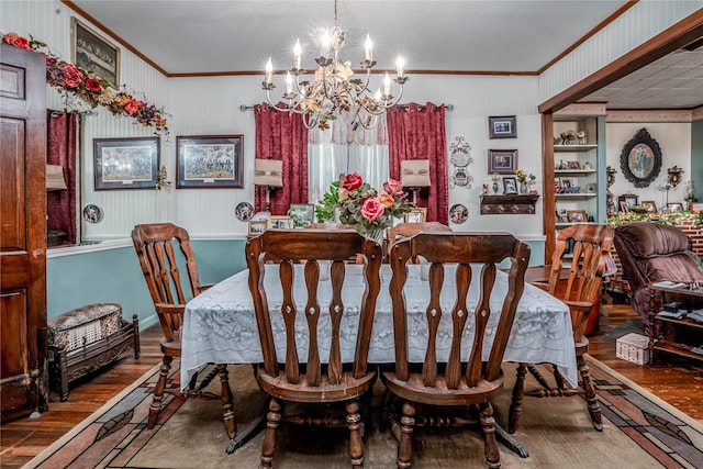 dining area with an inviting chandelier, ornamental molding, built in features, and hardwood / wood-style flooring