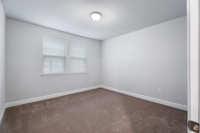 empty room with dark carpet