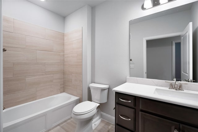 full bathroom with vanity, tiled shower / bath, and toilet