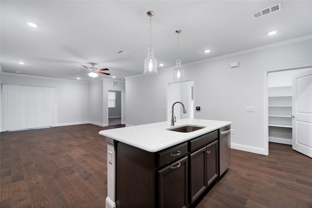 kitchen with sink, stainless steel dishwasher, pendant lighting, ceiling fan, and a kitchen island with sink