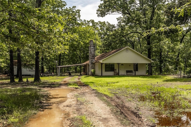 view of front of home with a porch and a carport