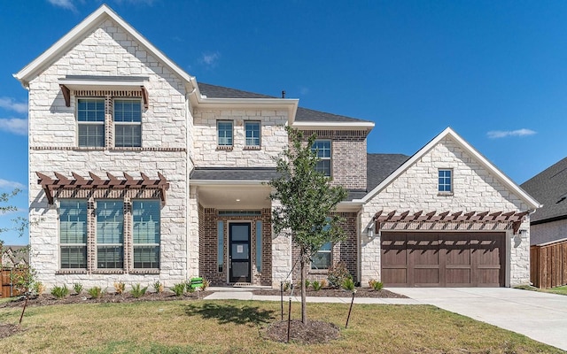 view of front of property with a garage, a front yard, driveway, and a shingled roof