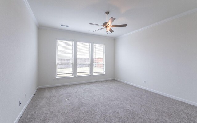 unfurnished room with carpet, ceiling fan, and crown molding