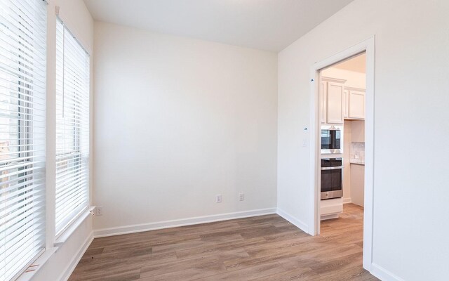 spare room featuring hardwood / wood-style floors