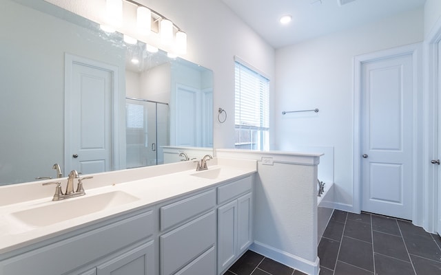 bathroom featuring dual vanity, independent shower and bath, and tile floors