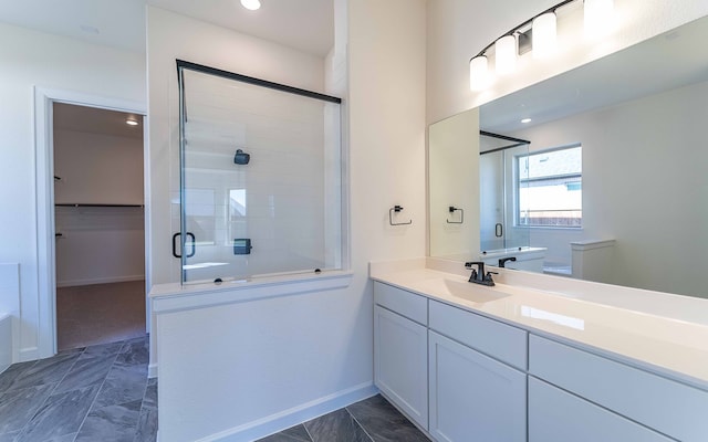 bathroom with tile floors, walk in shower, and oversized vanity