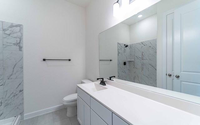 bathroom with tiled shower, oversized vanity, toilet, and tile floors