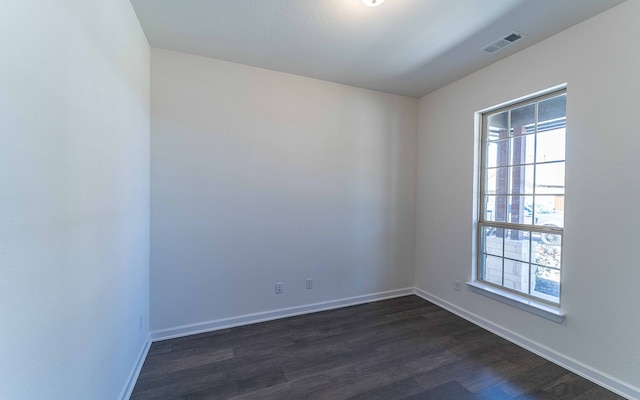 spare room featuring dark hardwood / wood-style floors