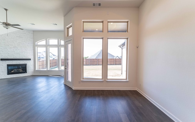 unfurnished living room featuring high vaulted ceiling, ceiling fan, dark hardwood / wood-style flooring, and a fireplace