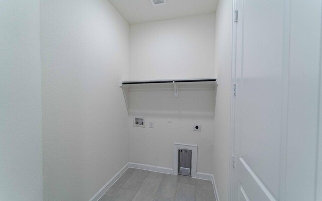 clothes washing area featuring gas dryer hookup, electric dryer hookup, and washer hookup