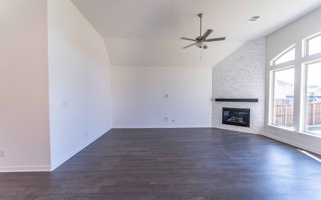 unfurnished living room featuring dark hardwood / wood-style floors, vaulted ceiling, and a fireplace