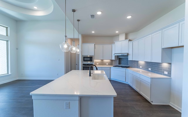 kitchen featuring dark hardwood / wood-style flooring, gas cooktop, tasteful backsplash, stainless steel oven, and sink