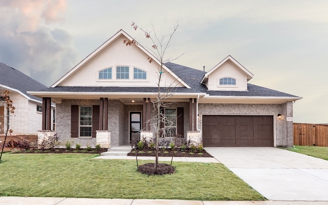 view of front of home featuring a porch, fence, concrete driveway, a front yard, and a shingled roof