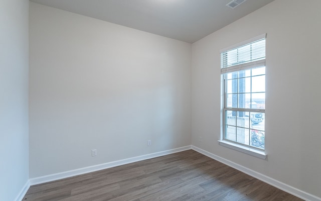 unfurnished room with a wealth of natural light and wood-type flooring