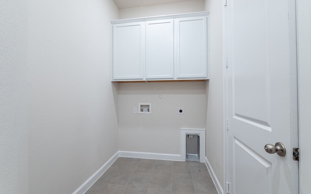 laundry room with gas dryer hookup, tile flooring, hookup for a washing machine, electric dryer hookup, and cabinets