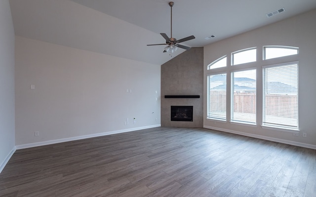 unfurnished living room featuring high vaulted ceiling, ceiling fan, a fireplace, and wood-type flooring