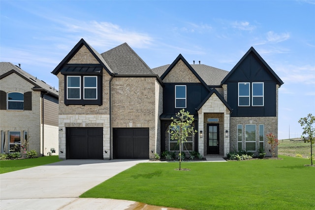 view of front of property featuring a front yard and a garage