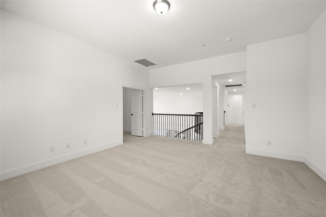 unfurnished room featuring light colored carpet