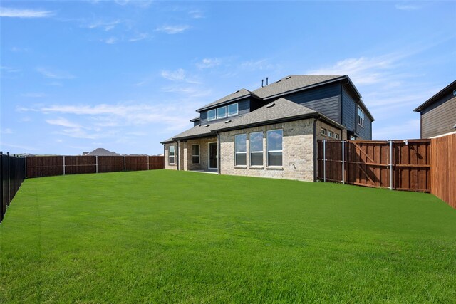 rear view of house with a lawn