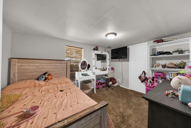 bedroom with a textured ceiling and dark carpet