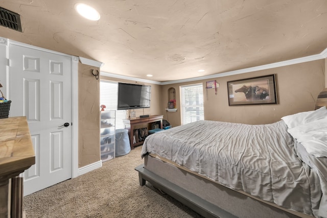 bedroom with carpet and crown molding