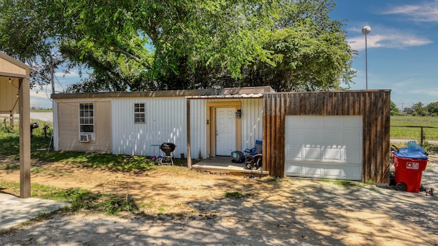 exterior space with a garage and an outdoor structure