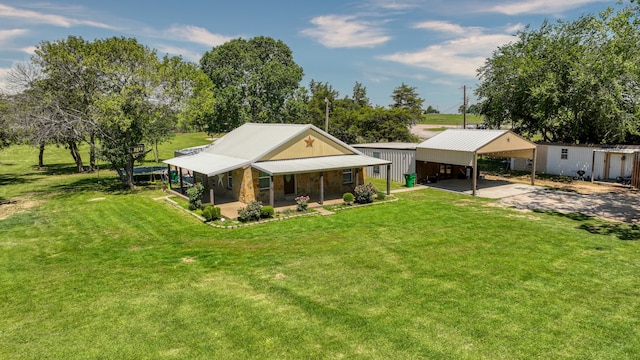 rear view of house with a carport and a yard