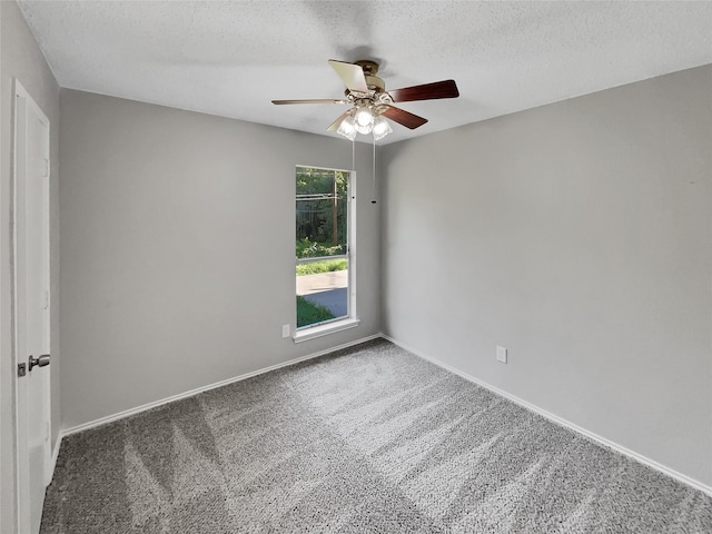 carpeted empty room featuring ceiling fan and a textured ceiling