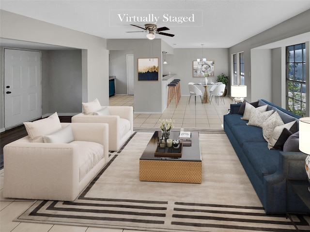 living room featuring ceiling fan with notable chandelier and light tile patterned flooring