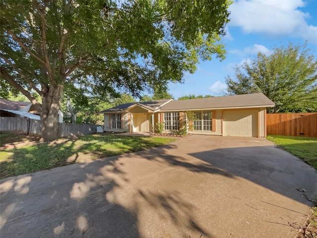 ranch-style house with a garage and a front lawn