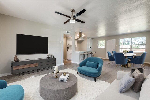 bedroom with hardwood / wood-style flooring, a textured ceiling, and ceiling fan