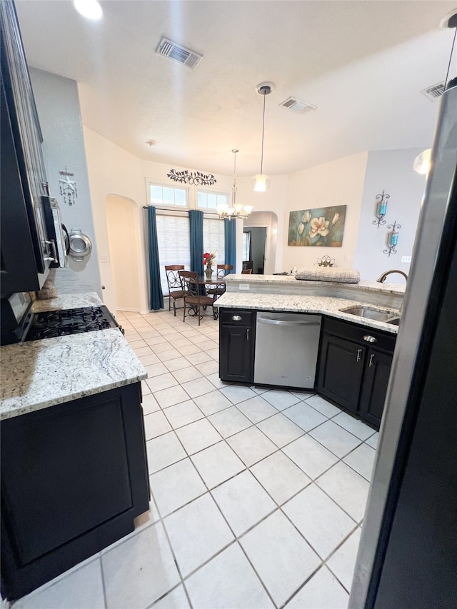 kitchen with sink, dishwasher, light tile floors, and hanging light fixtures