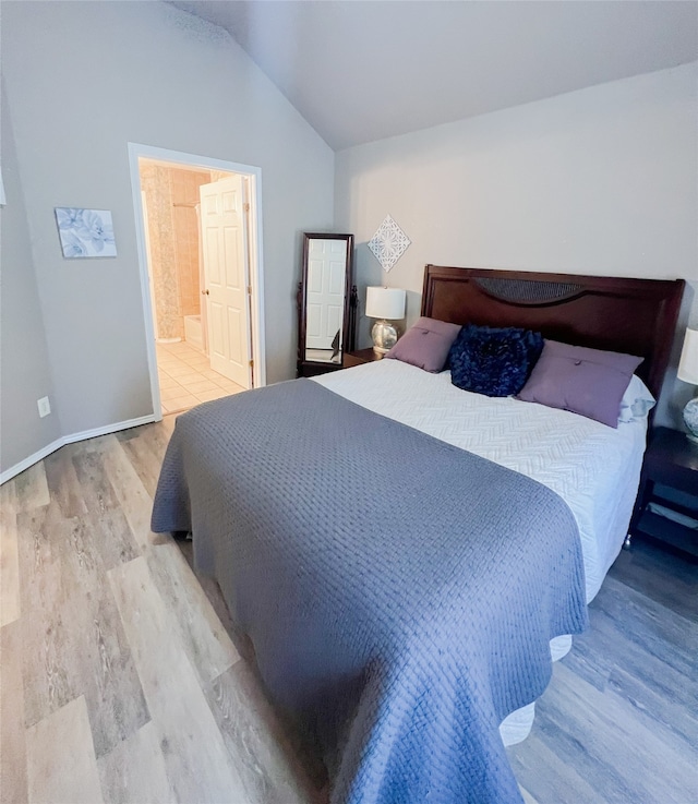 bedroom with light hardwood / wood-style flooring and vaulted ceiling